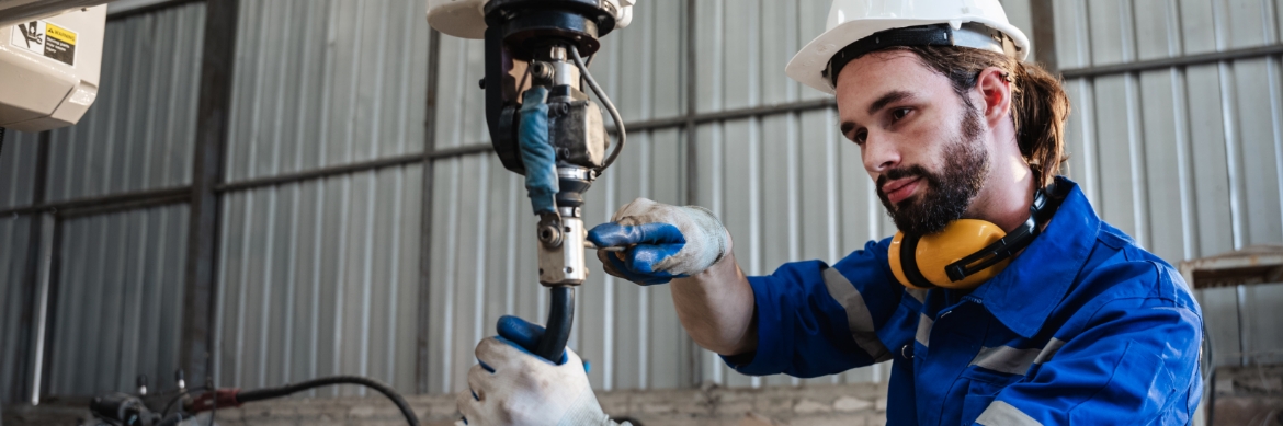 A man working on a machine in a factory.