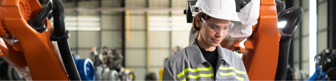 A worker wearing a hard hat in a warehouse.