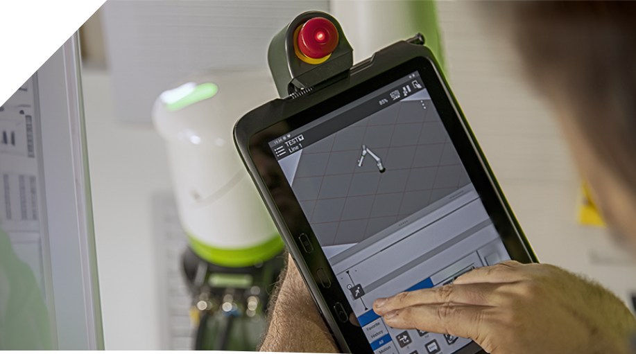 A person is using a tablet to design a robot.